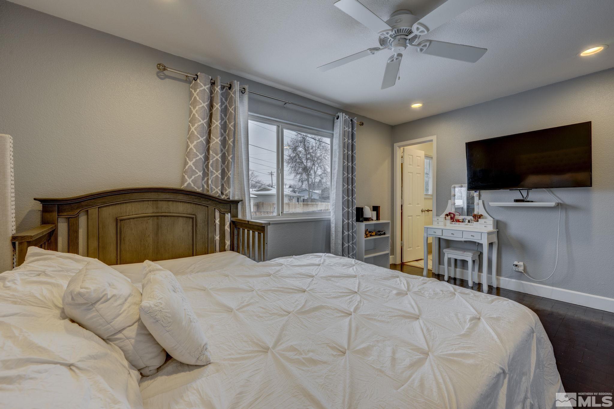 3450 West 7th Street Reno, NV 89503 - Photo 29 of 40 a bedroom with a bed and a flat screen tv