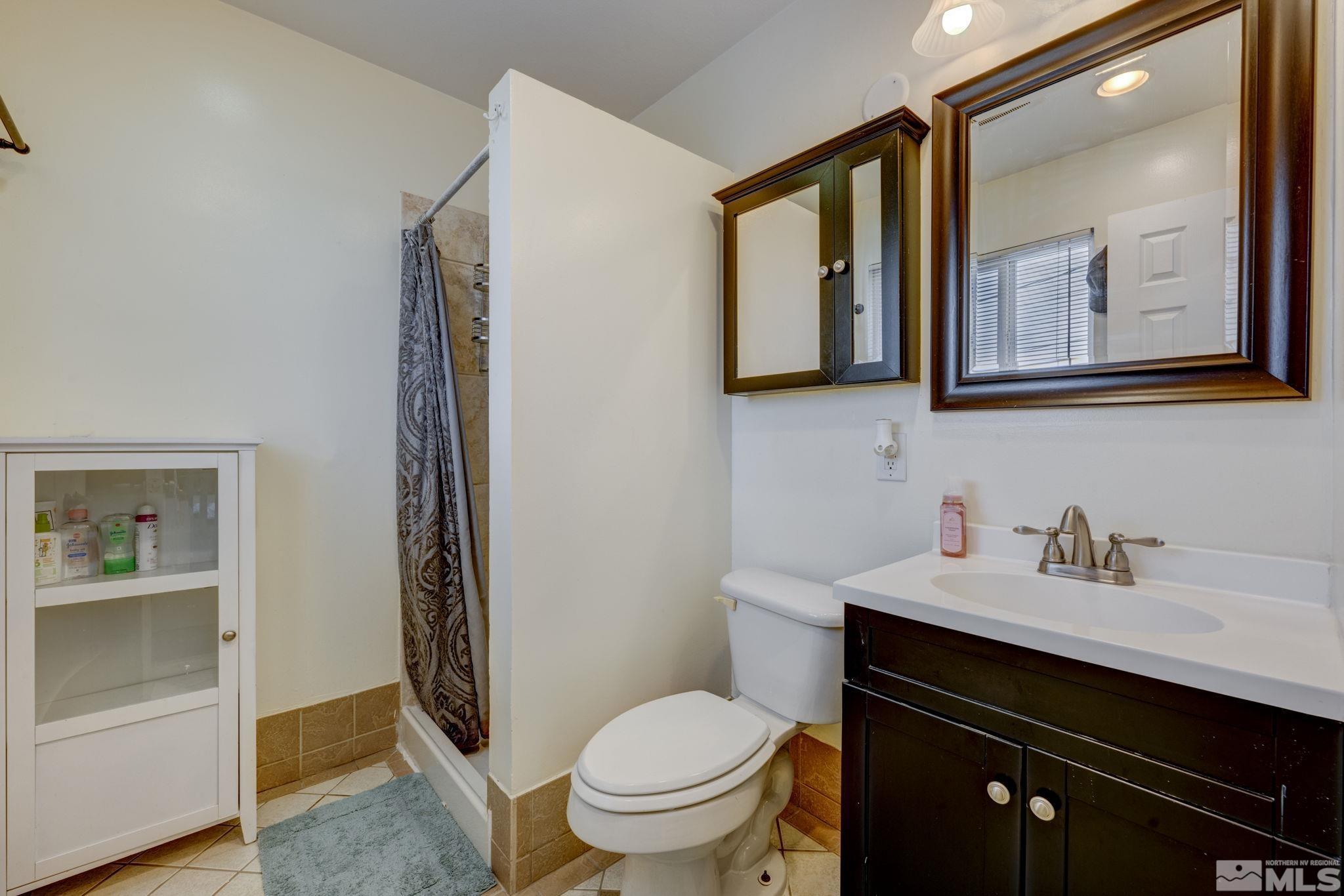 3450 West 7th Street Reno, NV 89503 - Photo 30 of 40 a bathroom with a toilet sink and mirror