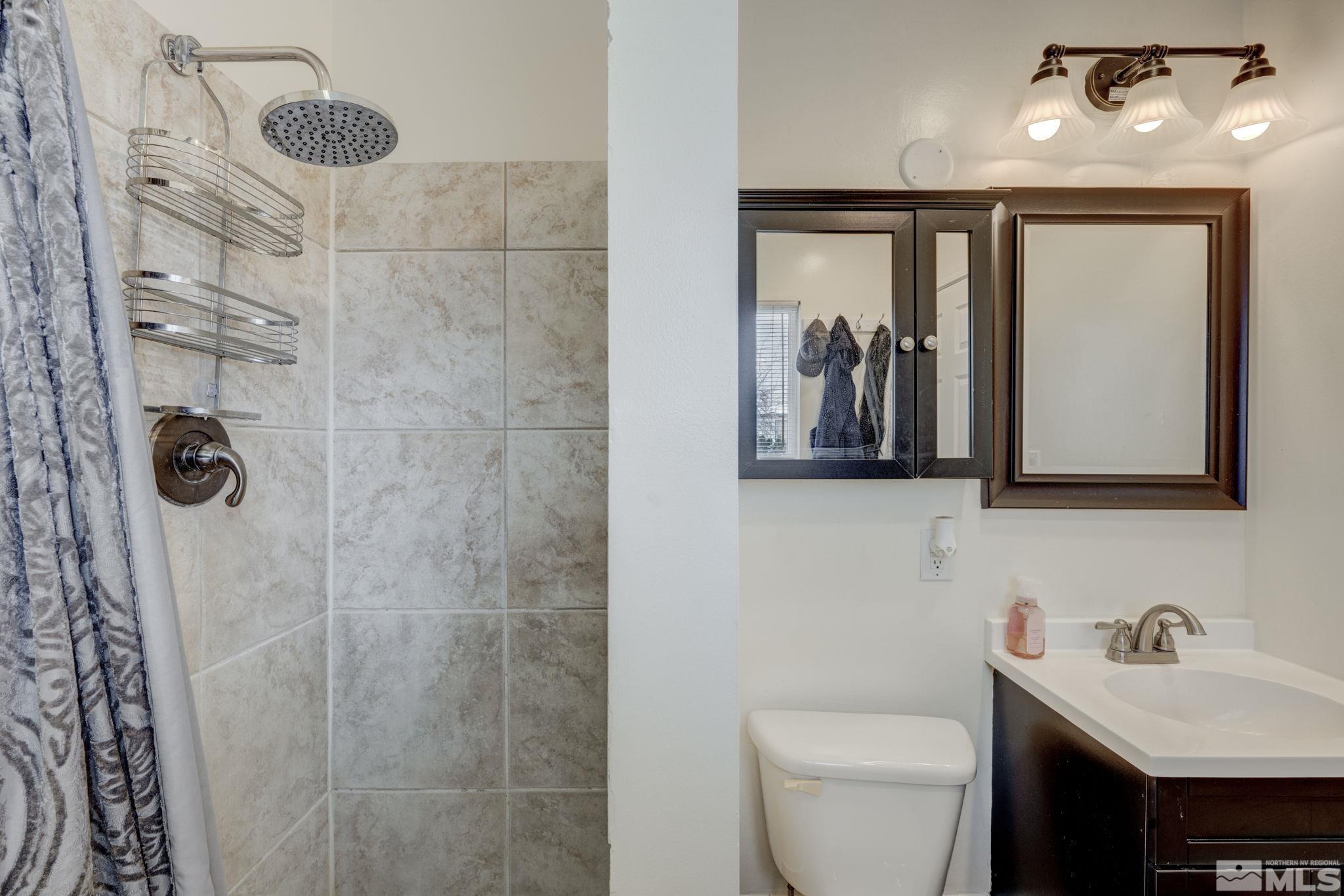 3450 West 7th Street Reno, NV 89503 - Photo 31 of 40 a bathroom with a toilet sink and mirror