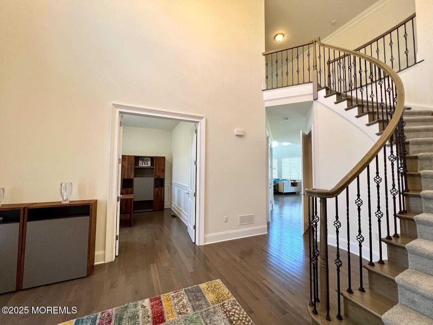 16 Exeter Way Holmdel, NJ 07733 - Photo 22 of 57 a view of a hallway with wooden floor and stairs