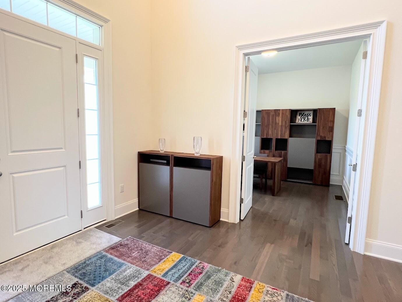 16 Exeter Way Holmdel, NJ 07733 - Photo 23 of 57 a view of a bedroom with a bed and wooden floor