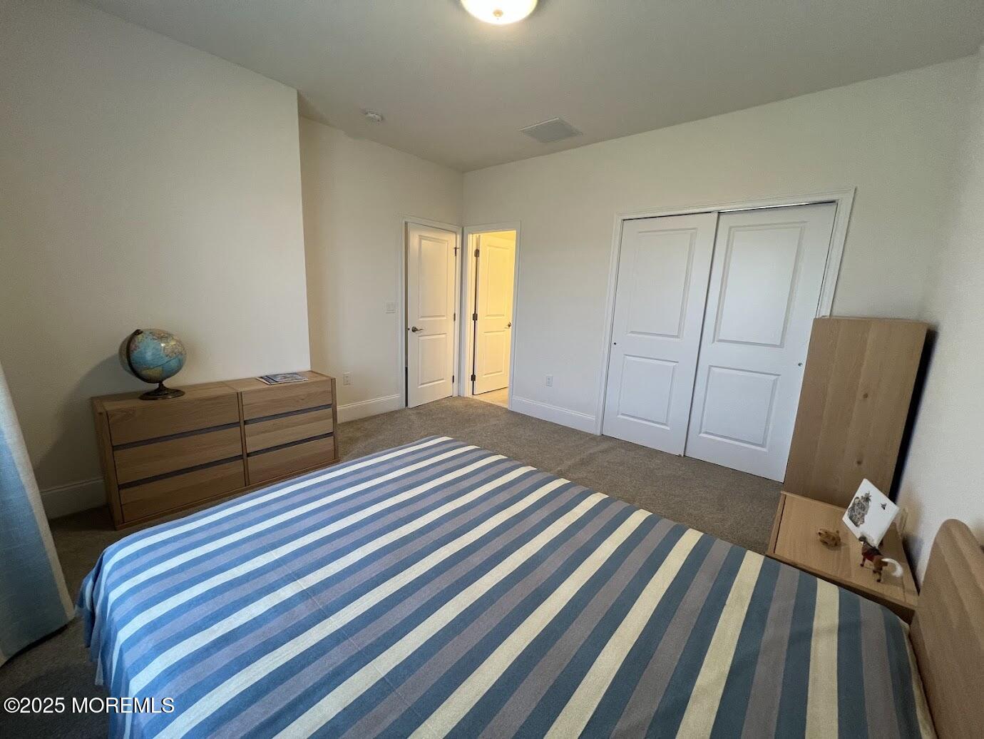 16 Exeter Way Holmdel, NJ 07733 - Photo 35 of 57 a bedroom with a bed and wooden floor