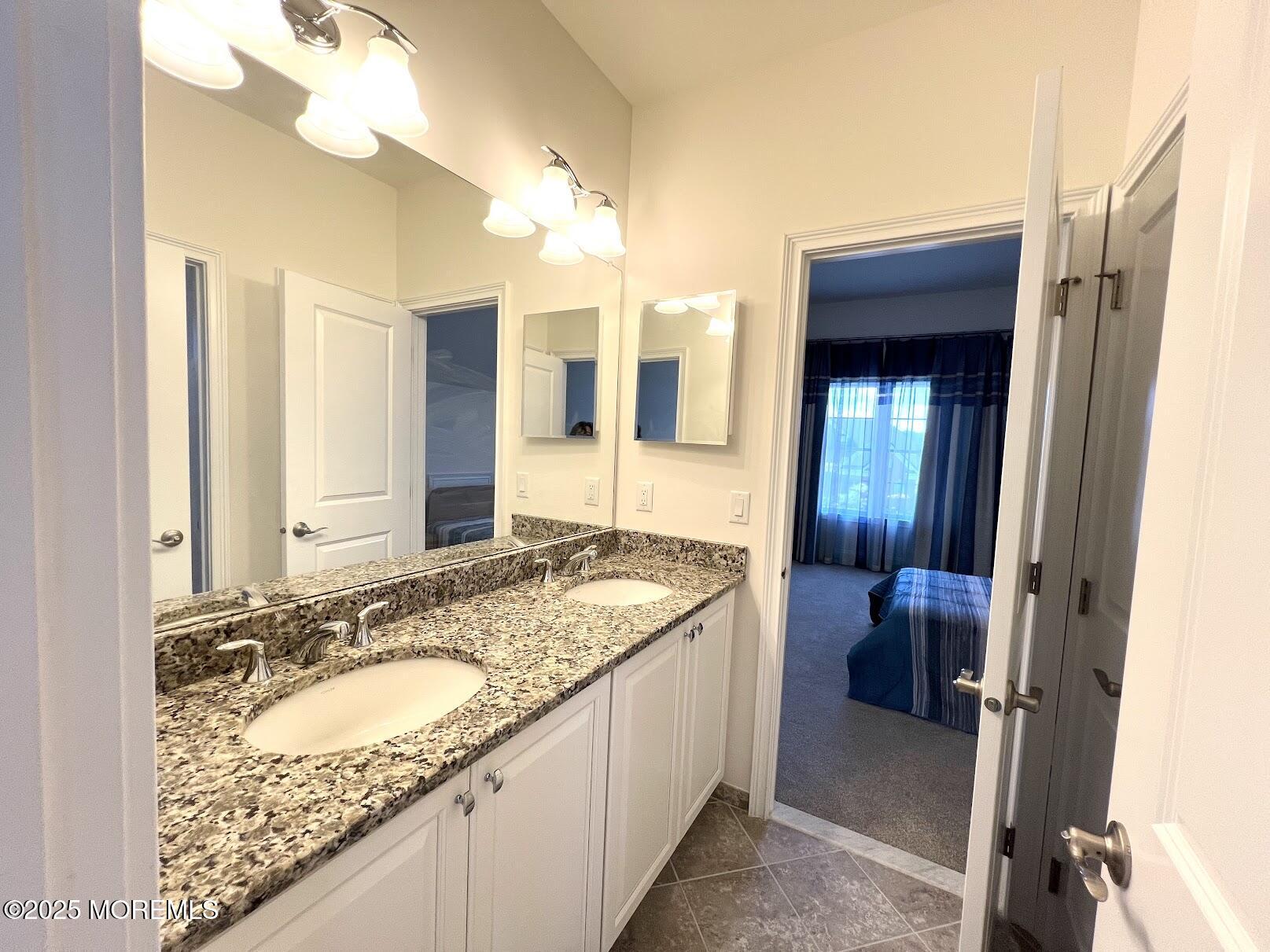 16 Exeter Way Holmdel, NJ 07733 - Photo 42 of 57 a bathroom with a granite countertop sink and a mirror