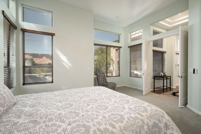 a bedroom with a large bed and a window