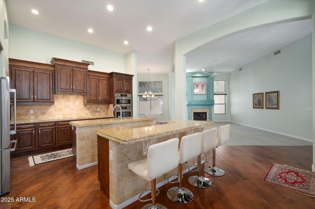 a large kitchen with a table and chairs in it