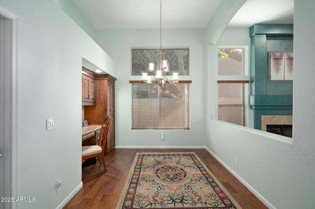 a view of a hallway to a livingroom with furniture