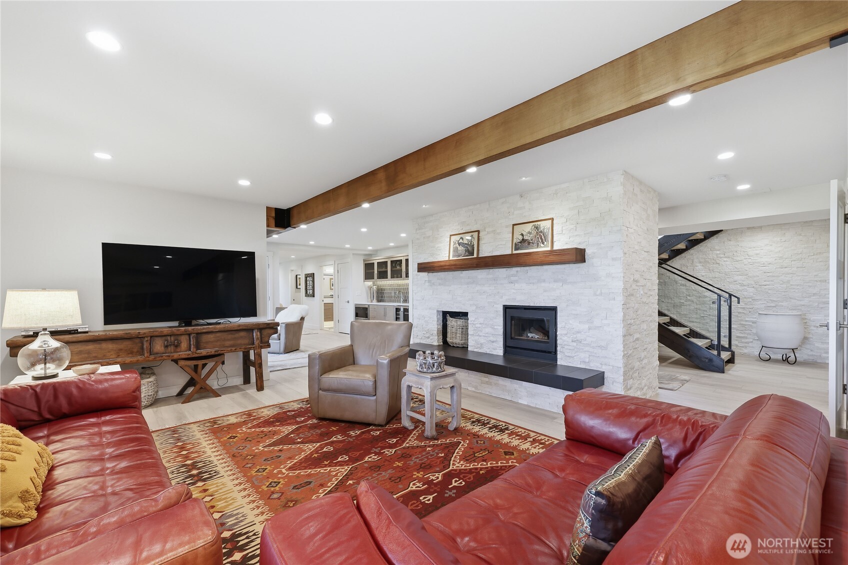 37709 Olympic View Road Northeast Hansville, WA 98340 - Photo 29 of 40 a living room with furniture a flat screen tv and a fireplace
