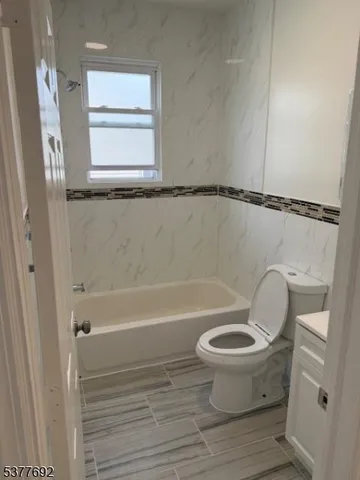a bathroom with a toilet and a bathtub