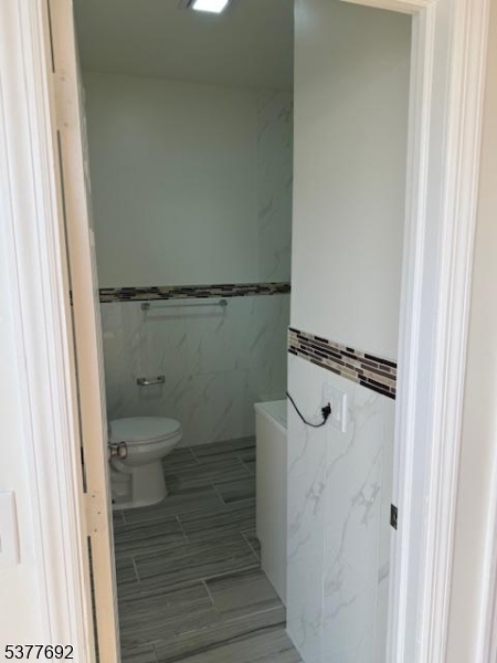 609 South 19th Street, Unit 2 Newark, NJ 07103 - Photo 6 of 8 a bathroom with a granite countertop shower and a toilet