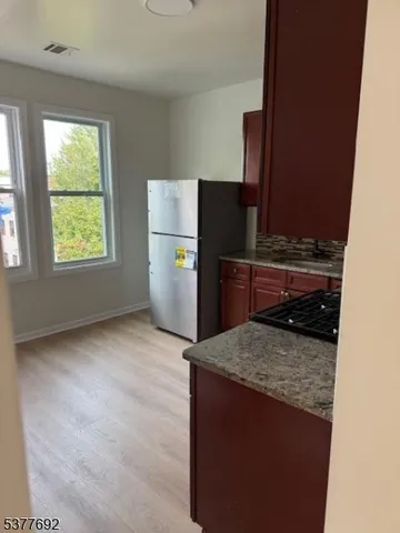 a kitchen with a refrigerator and a stove top oven