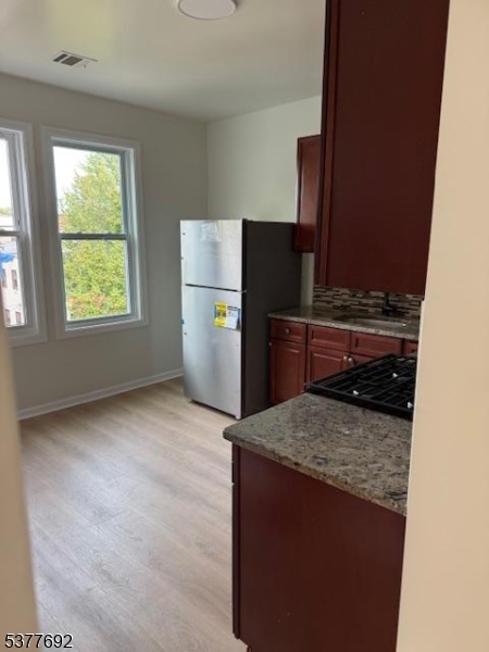 609 South 19th Street, Unit 2 Newark, NJ 07103 - Photo 8 of 8 a kitchen with a refrigerator and a stove top oven