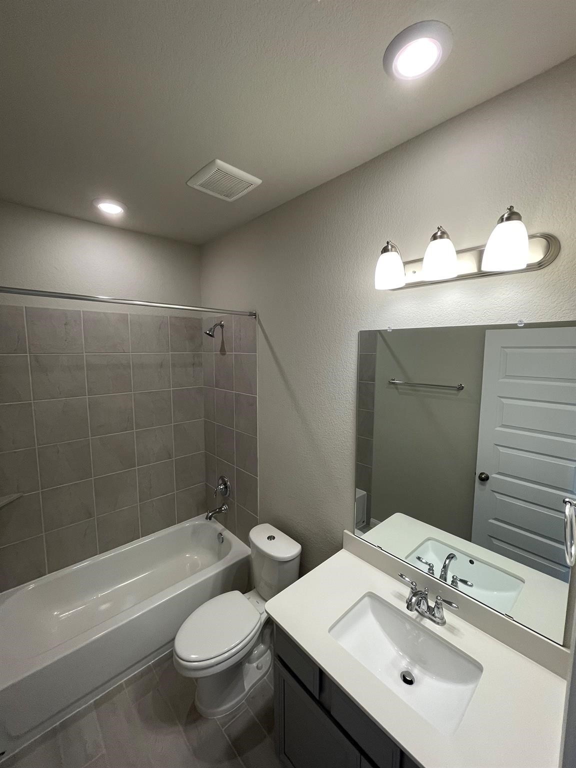 2035 Myrtle Oak Street Conroe, TX 77304 - Photo 12 of 20 a bathroom with a sink a toilet and shower