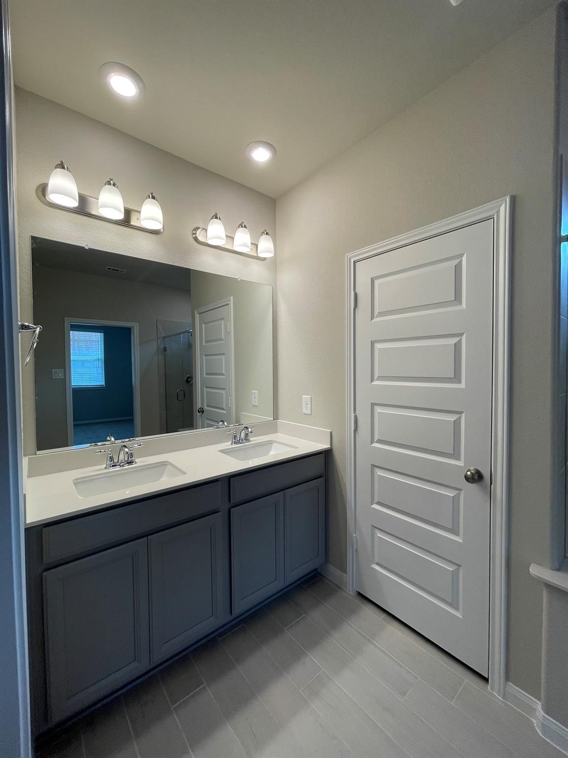 2035 Myrtle Oak Street Conroe, TX 77304 - Photo 14 of 20 a bathroom with a double vanity sink and a mirror