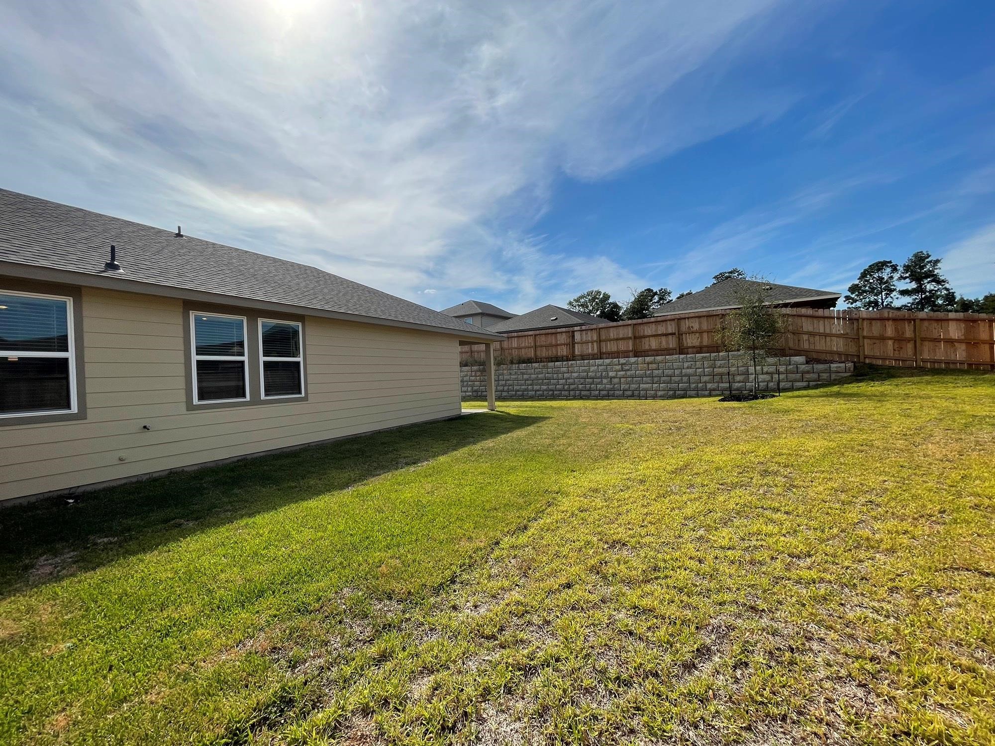 2035 Myrtle Oak Street Conroe, TX 77304 - Photo 18 of 20 a view of a large pool with lawn chairs under an umbrella