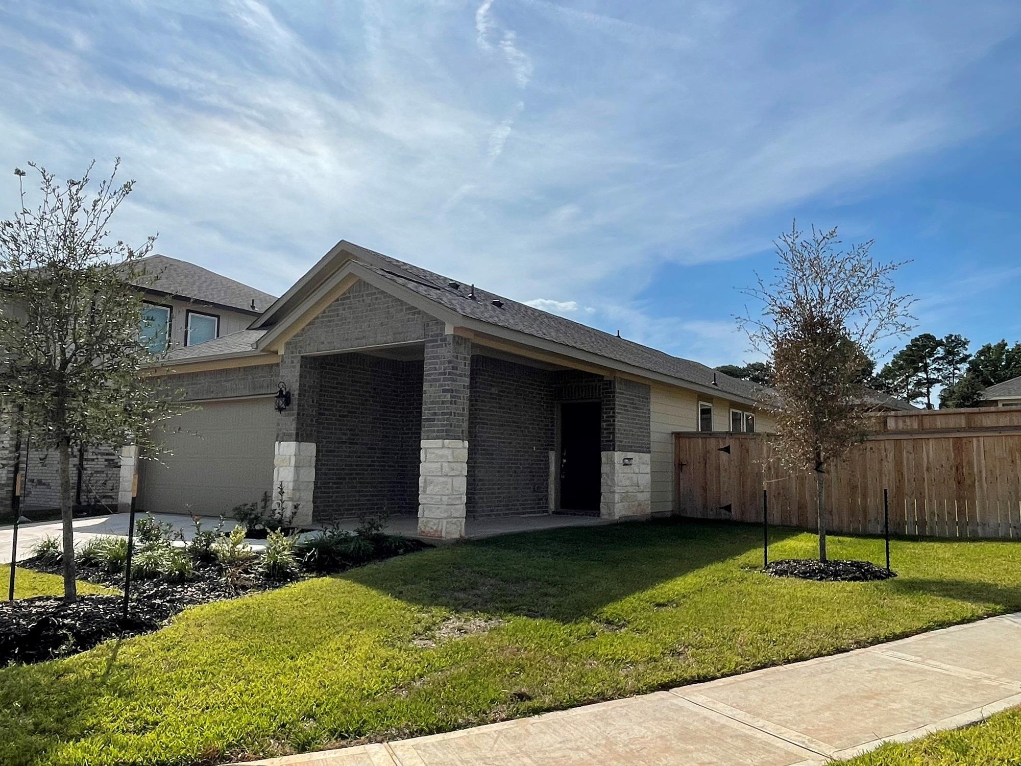 2035 Myrtle Oak Street Conroe, TX 77304 - Photo 2 of 20 a view of a house with a yard and large tree