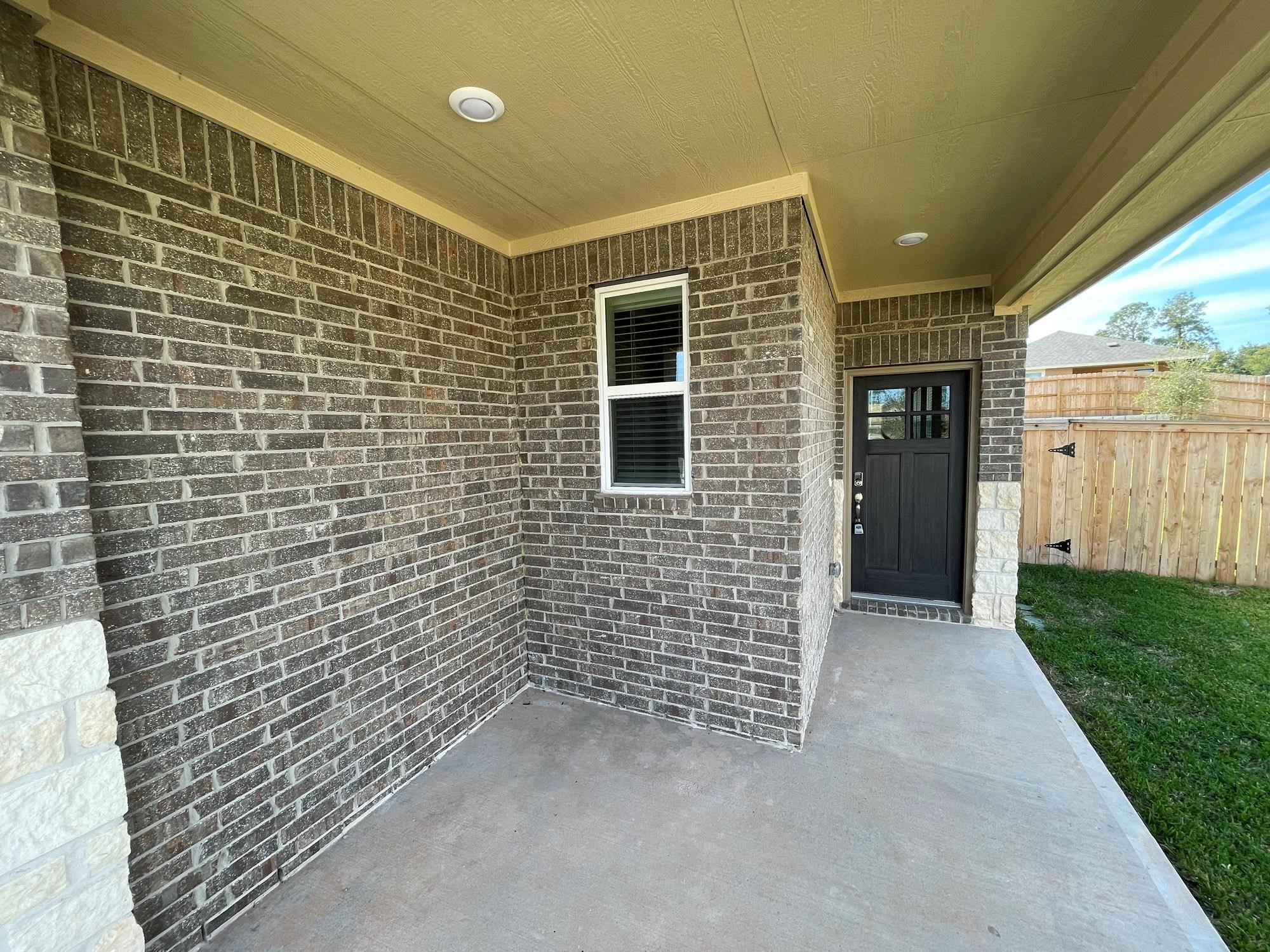 2035 Myrtle Oak Street Conroe, TX 77304 - Photo 4 of 20 a view of a brick house with many windows