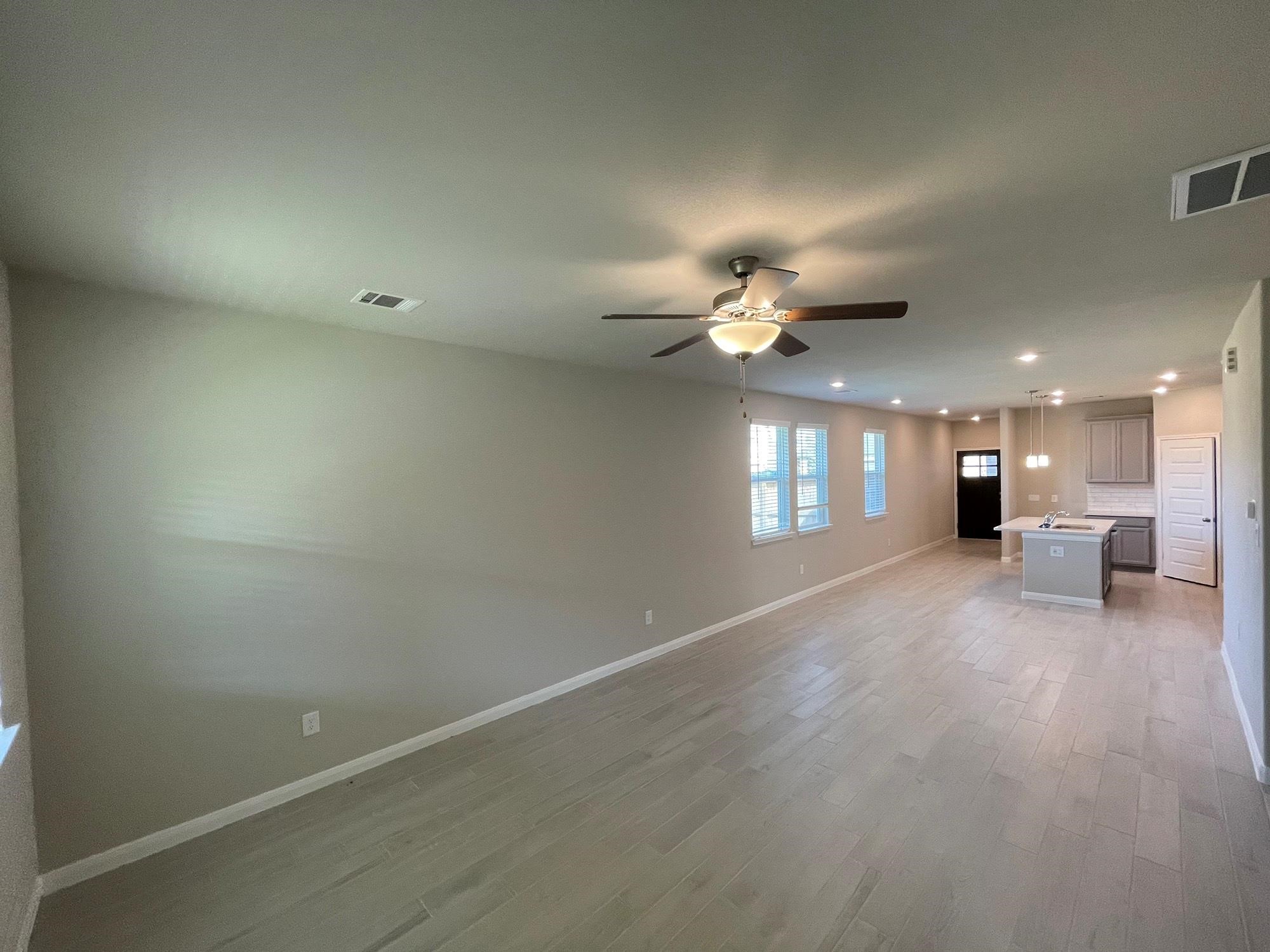 2035 Myrtle Oak Street Conroe, TX 77304 - Photo 8 of 20 a view of a livingroom with a ceiling fan and window