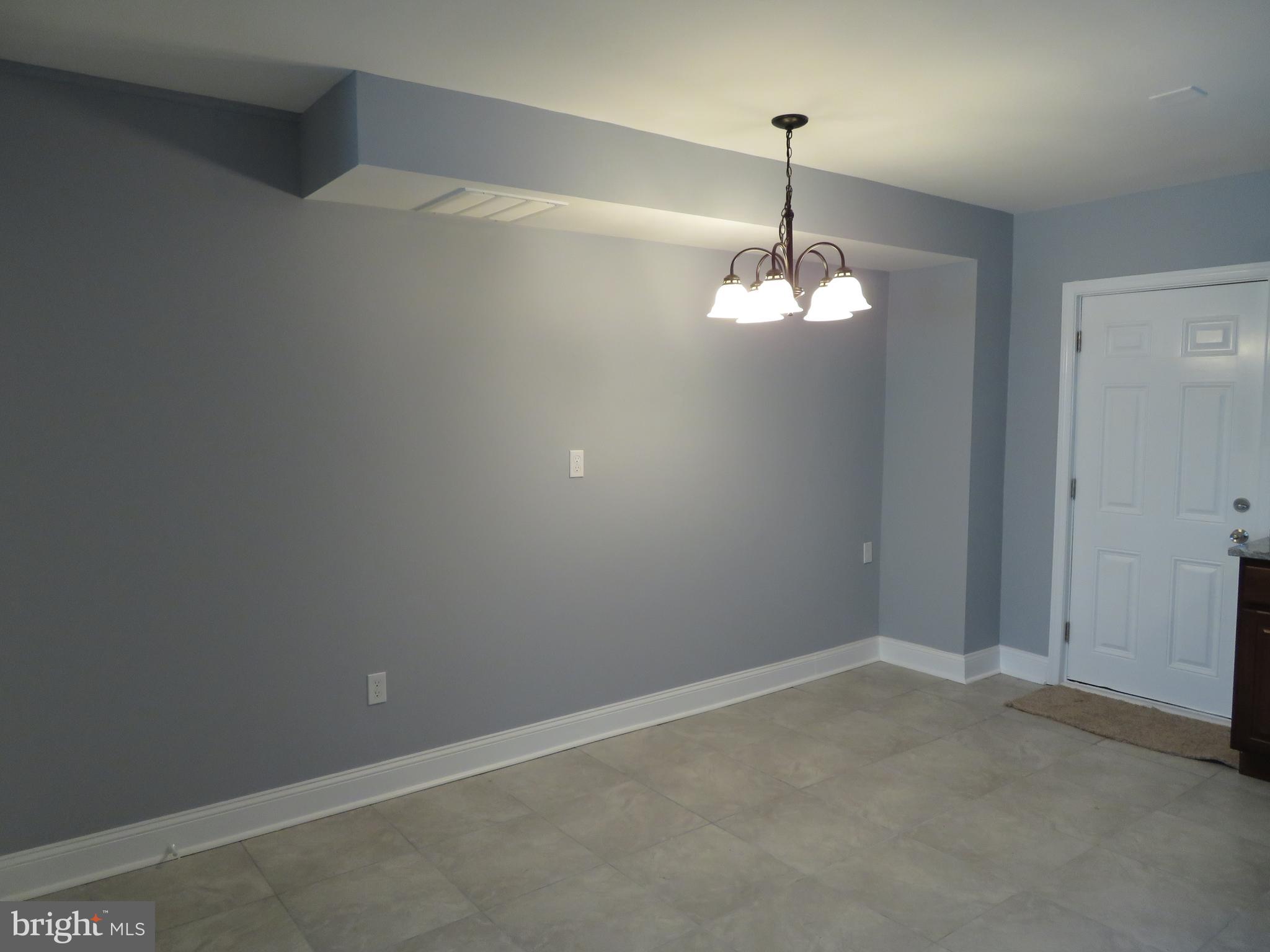 4005 Pimlico Road Baltimore, MD 21215 - Photo 10 of 45 Dining Area Chandelier and Door to Back Yard