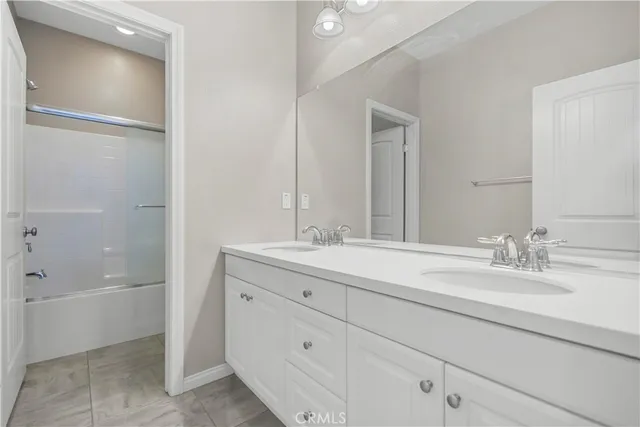 a bathroom with a granite countertop sink mirror and double
