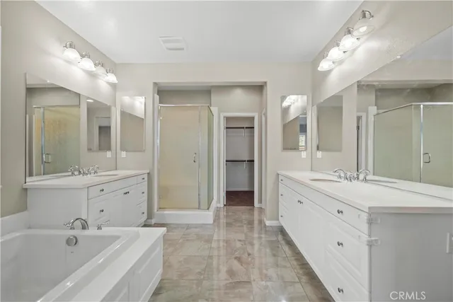 a spacious bathroom with a double vanity sink mirror double and bathtub