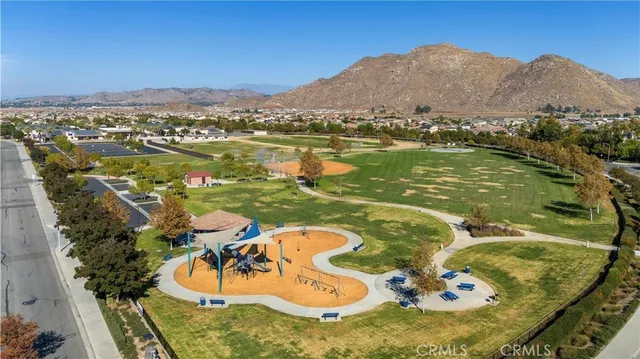 an aerial view of a house with outdoor space swimming pool and mountains