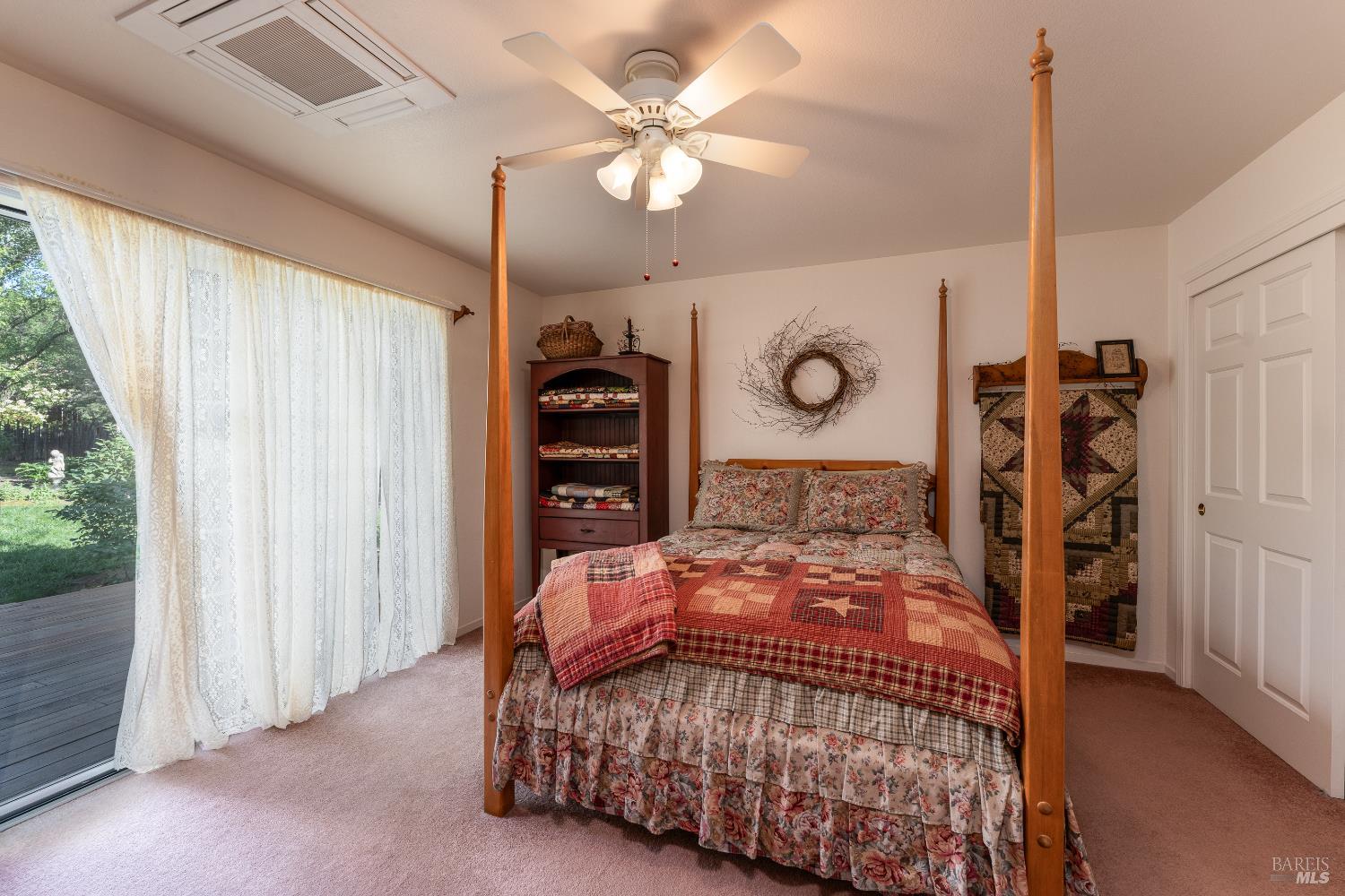 1991 Fern Canyon Road Ukiah, CA 95482 - Photo 16 of 19 a bedroom with a bed and a chandelier