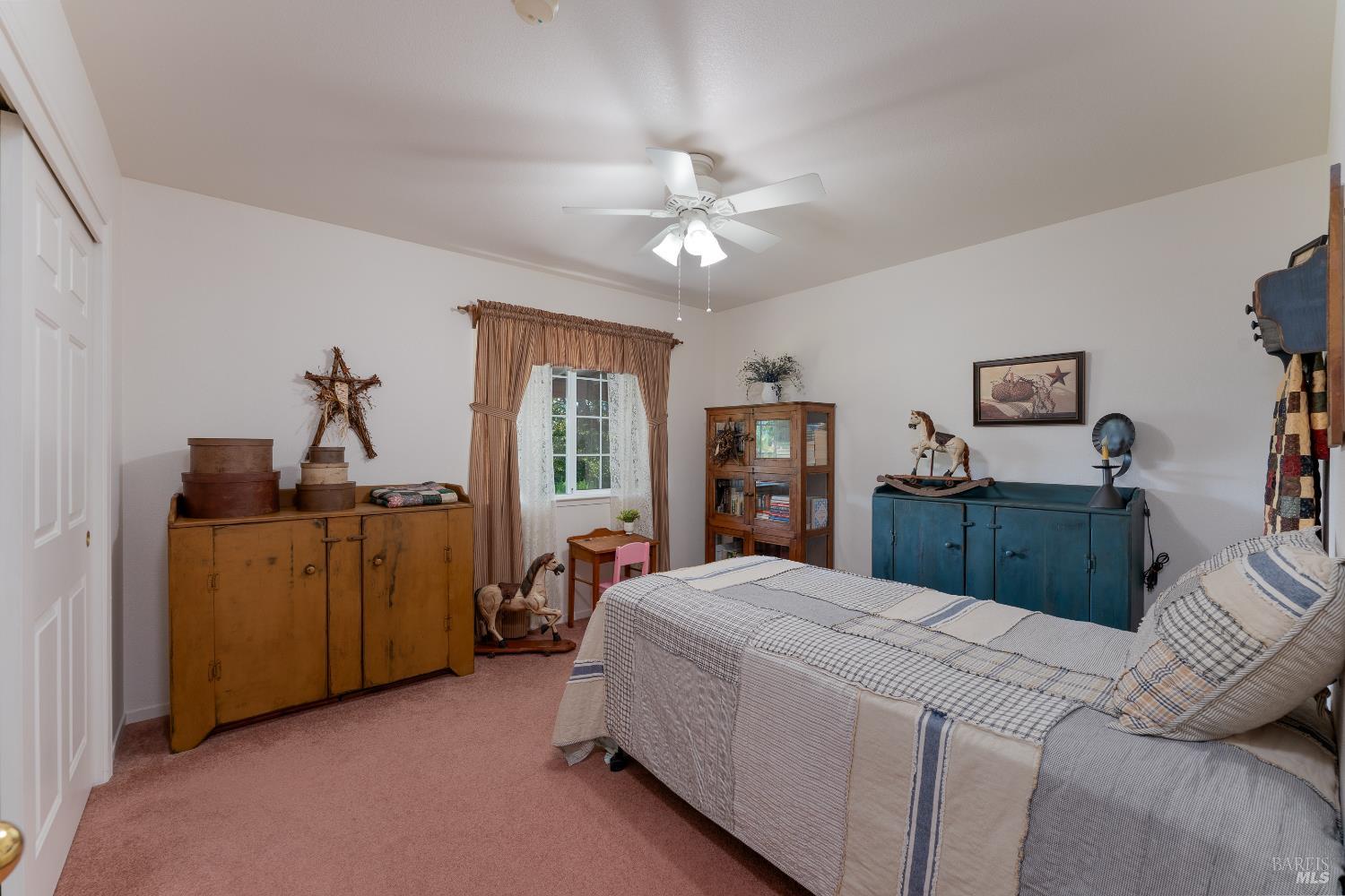 1991 Fern Canyon Road Ukiah, CA 95482 - Photo 19 of 19 a bed room with a bed and a chandelier