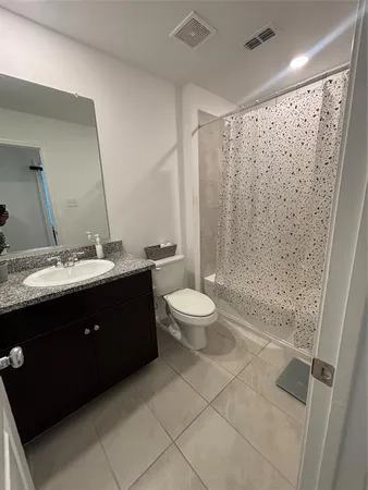 a bathroom with a double vanity sink toilet and shower