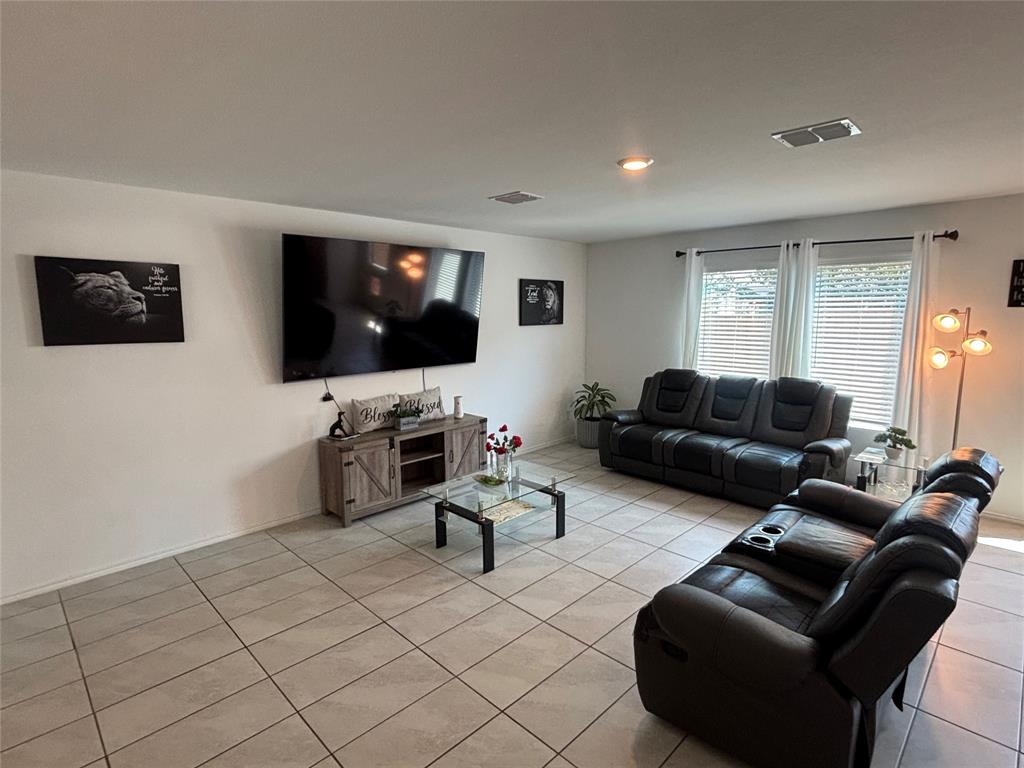 3386 Peyton Lila Road Dallas, TX 75212 - Photo 5 of 13 a living room with furniture and a flat screen tv