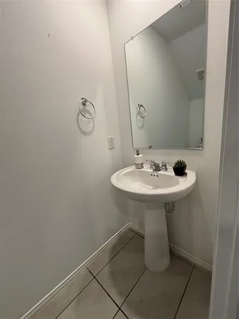 a bathroom with a sink toilet and a mirror