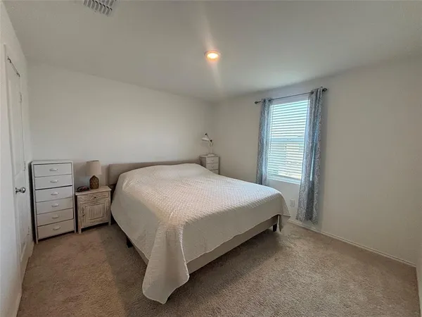 a bed room with a bed and a night stand