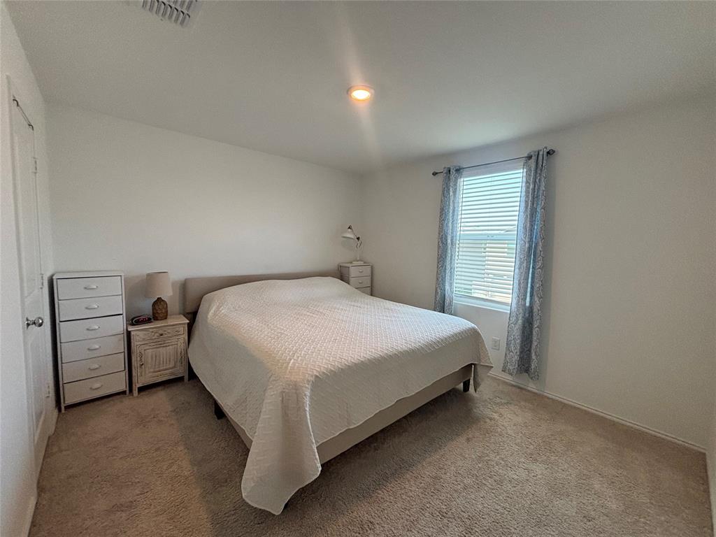 3386 Peyton Lila Road Dallas, TX 75212 - Photo 7 of 13 a bed room with a bed and a night stand