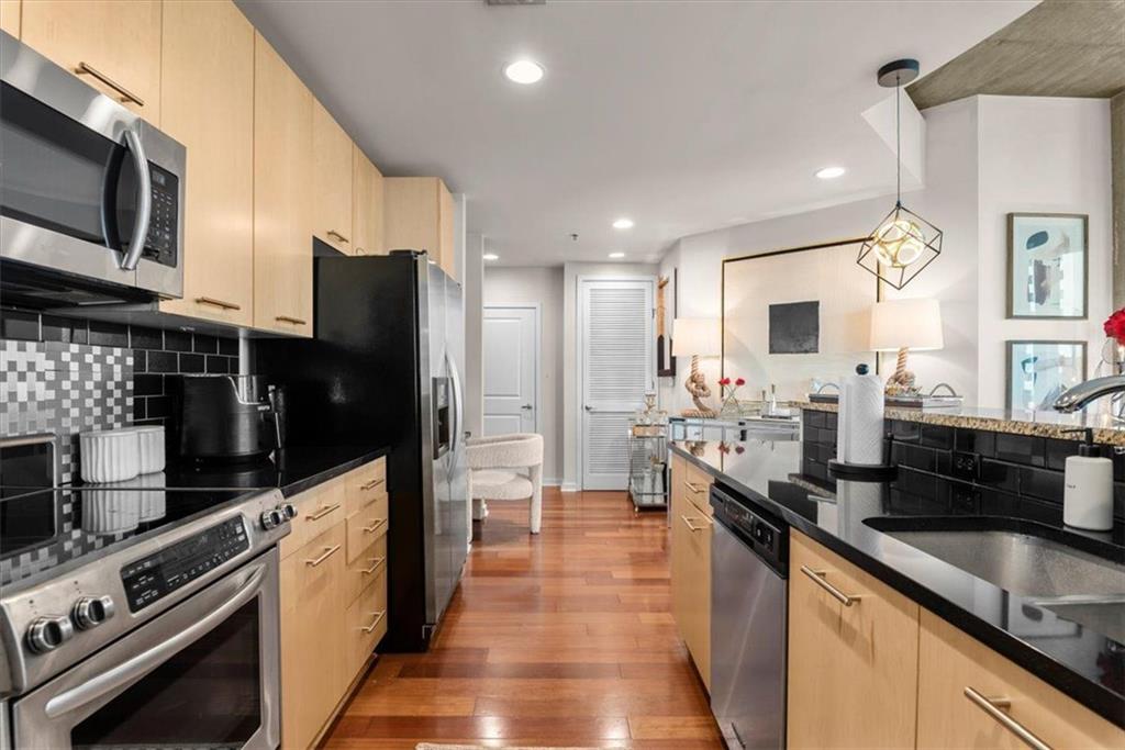 3324 Peachtree Road Northeast, Unit 902 Atlanta, GA 30326 - Photo 11 of 29 a large kitchen with stainless steel appliances