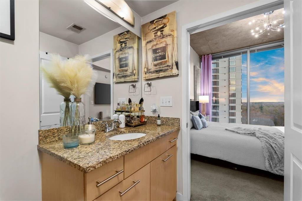 3324 Peachtree Road Northeast, Unit 902 Atlanta, GA 30326 - Photo 18 of 29 a bathroom with a granite countertop sink and a mirror