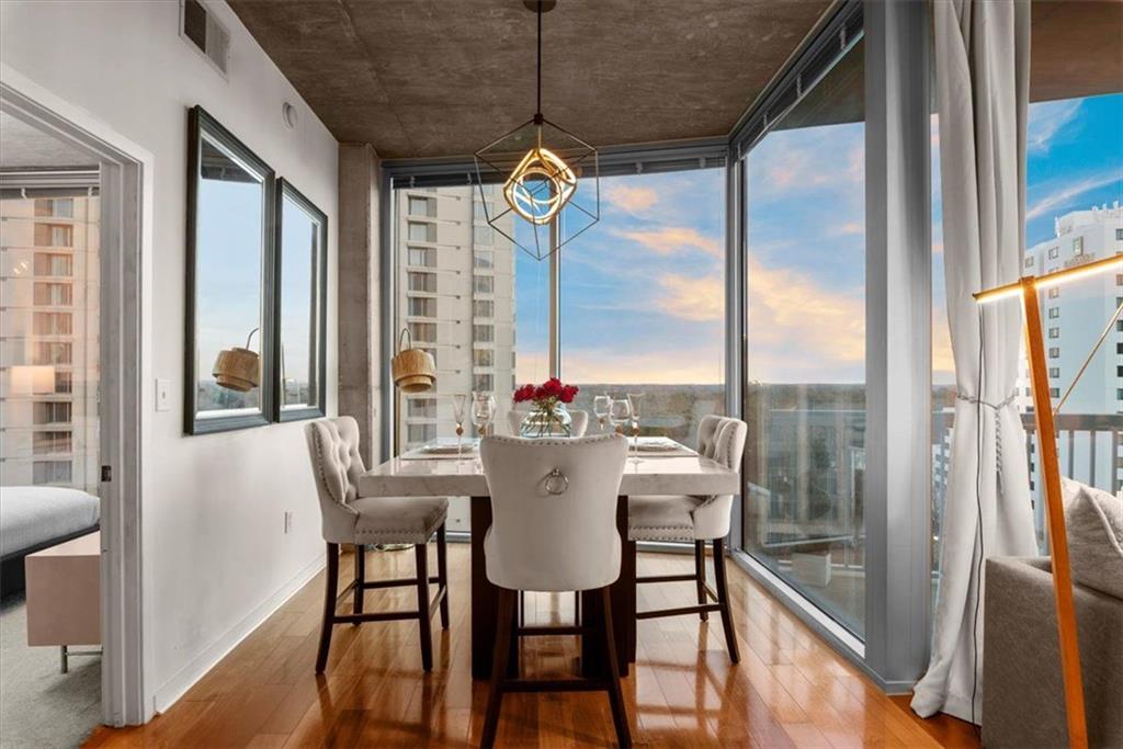 3324 Peachtree Road Northeast, Unit 902 Atlanta, GA 30326 - Photo 4 of 29 a view of a dining room with furniture large windows and wooden floor
