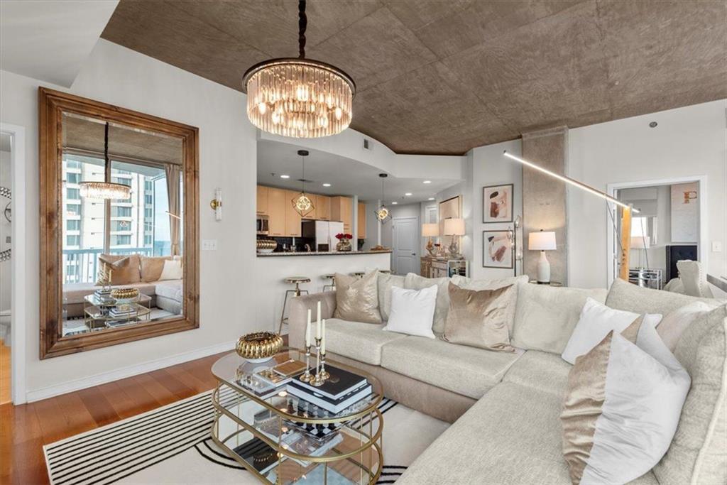 3324 Peachtree Road Northeast, Unit 902 Atlanta, GA 30326 - Photo 7 of 29 a living room with fireplace furniture and a chandelier