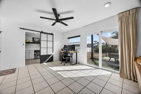 a bedroom with a bed and a large mirror