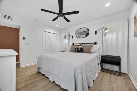 a bedroom with bed and a chandelier
