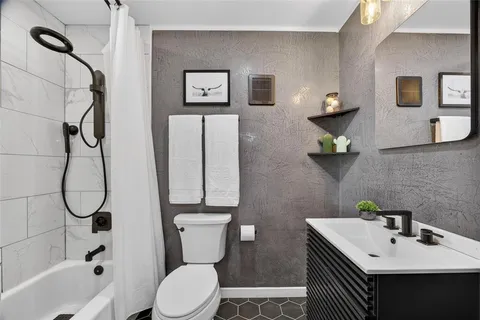 a bathroom with a sink toilet and shower