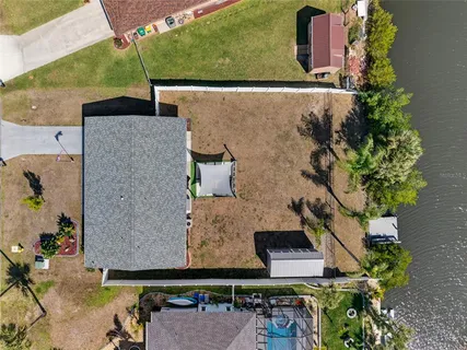 an aerial view of a house with a yard