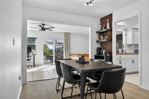 a view of a dining room and livingroom with furniture wooden floor and a rug