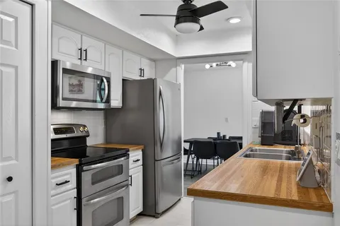 a kitchen with stainless steel appliances a stove refrigerator and microwave