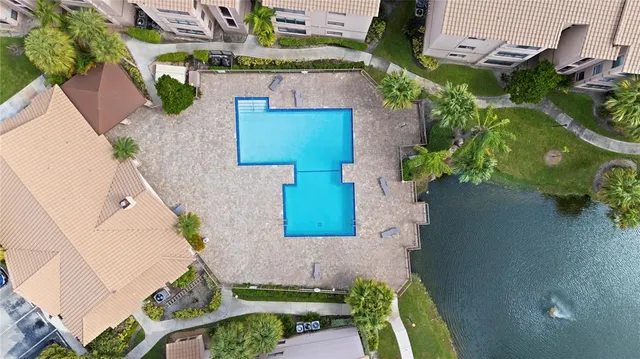 an aerial view of a house with a yard and a fountain