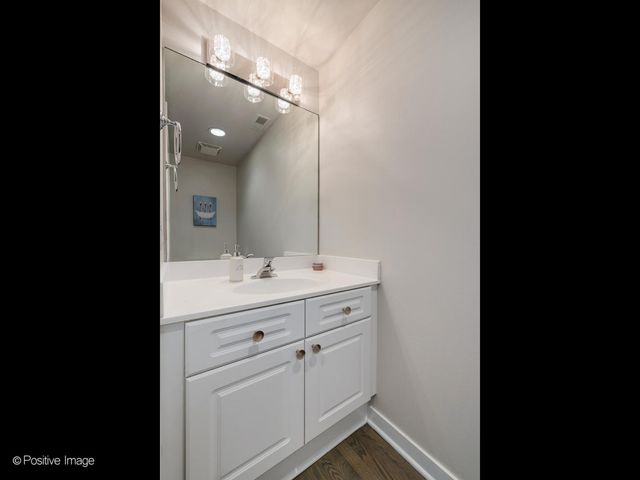 a bathroom with a sink vanity and mirror