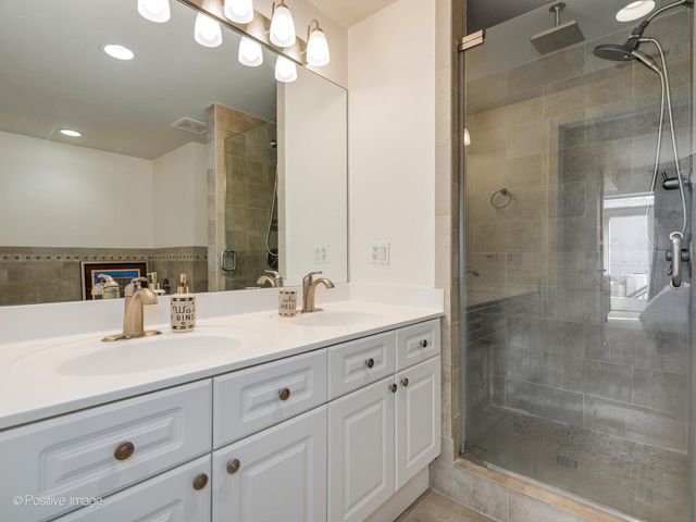 a bathroom with a shower sink and mirror