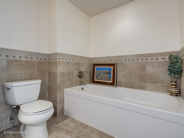 a bathroom with a toilet a sink and bathtub