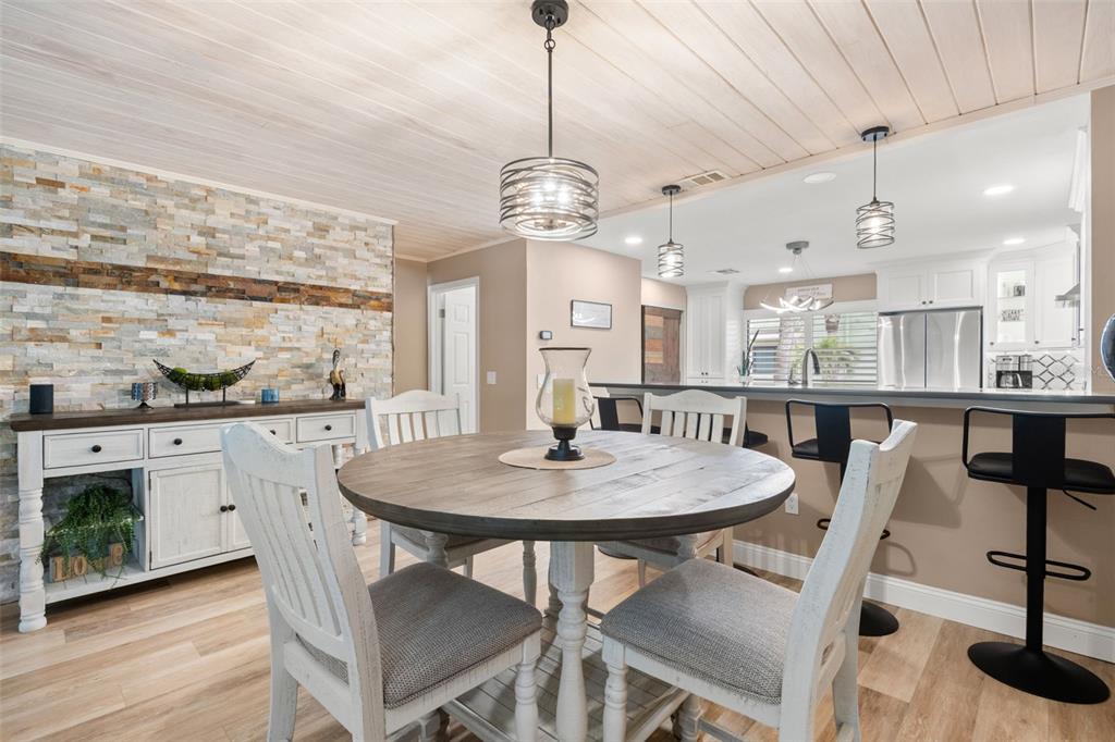 529 Sandy Hook Road Treasure Island, FL 33706 - Photo 11 of 55 a view of a dining room with furniture window and wooden floor