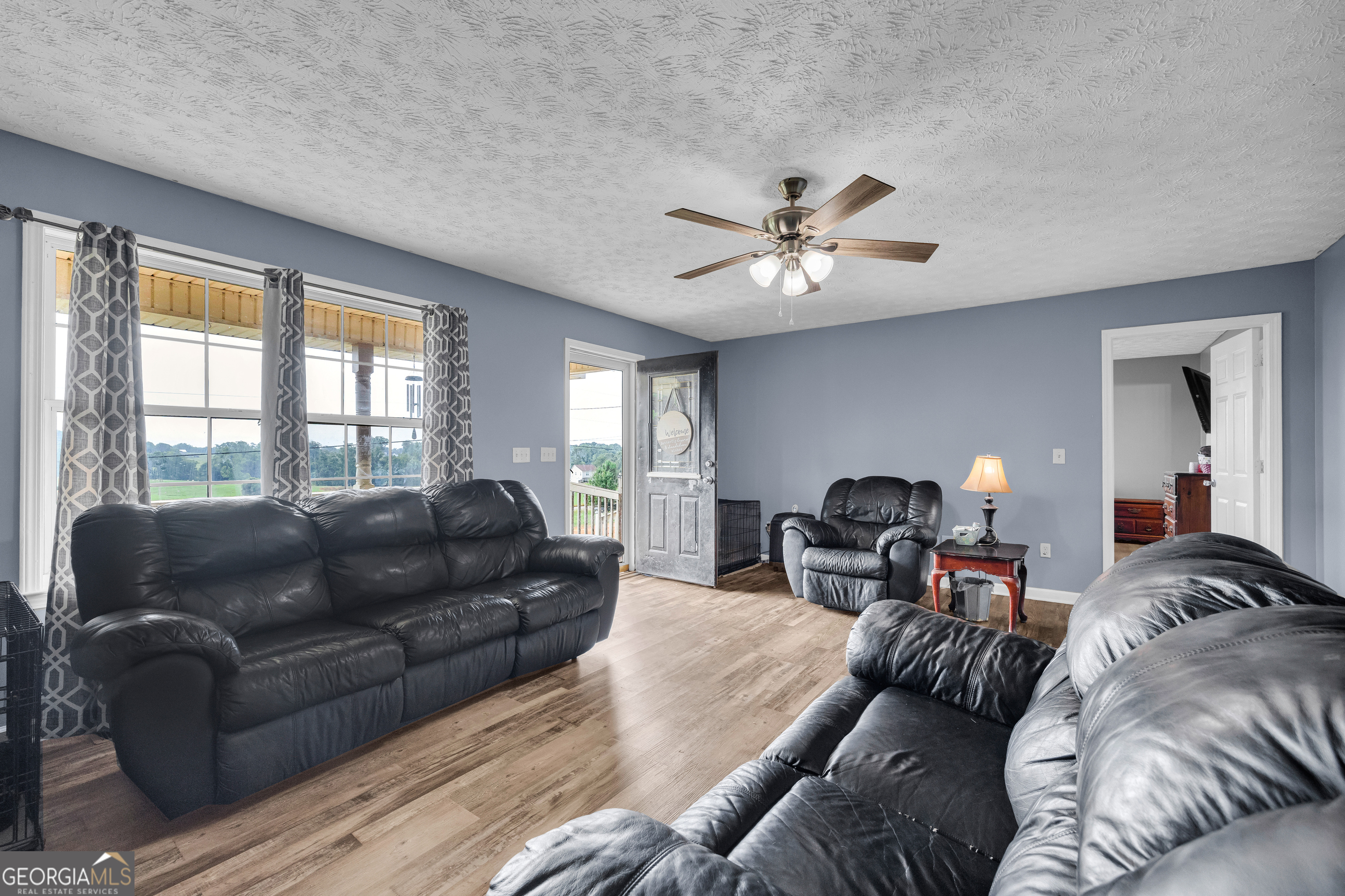 156 Shirley Road Royston, GA 30662 - Photo 7 of 29 a living room with furniture a couch and a chandelier