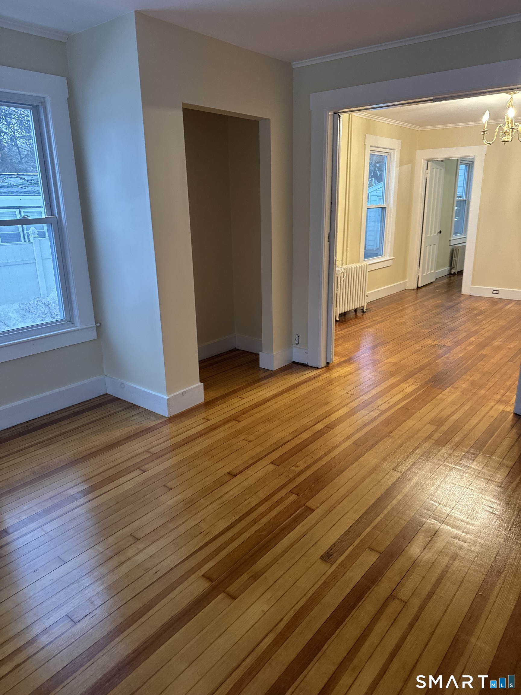 79 Meadow Street Seymour, CT 06483 - Photo 8 of 9 a view of an empty room with wooden floor and a window