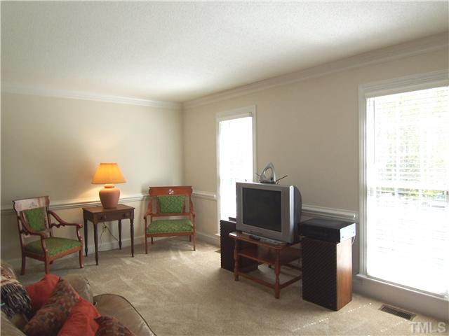 2016 Chichester Court Raleigh, NC 27615 - Photo 2 of 12 The welcoming hardwd-floored Foyer features crown/chair rail molding, coat closet, stairs to the 2nd flr & dbl drs to LR, FamilyRm & KIT. At right is the lg formal Living Rm w/flr-to-ceiling windows, deep crown/chair rail molding & NEW neutral carpet. Living Room